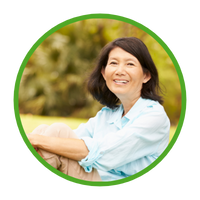 Middle-aged, slender, Asian lady with black hair and big smile